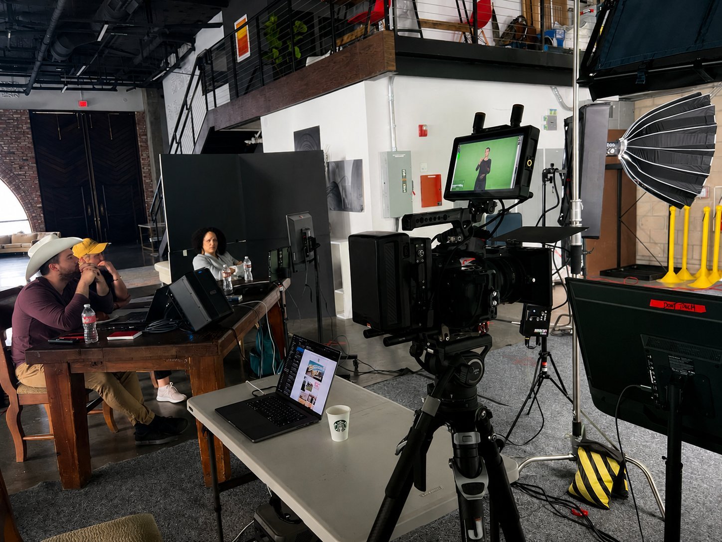 Rosa Lee Timm on a film set, observing playback at a monitor station with crew