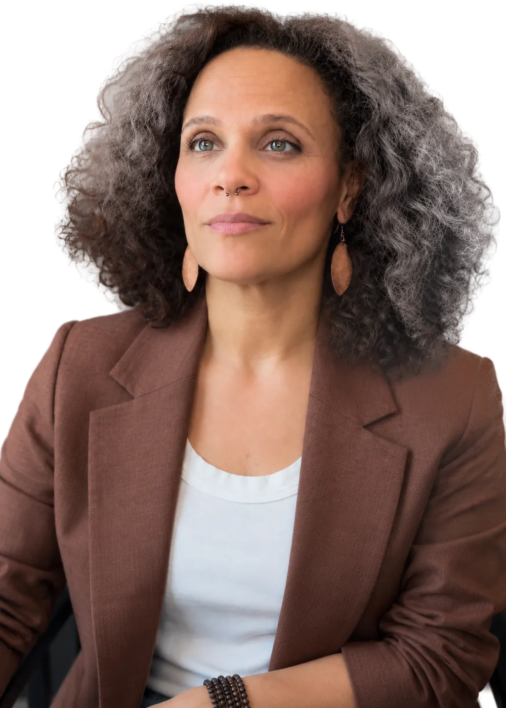 Portrait of Rosa Lee Timm in a brown blazer, seated and looking off to the side